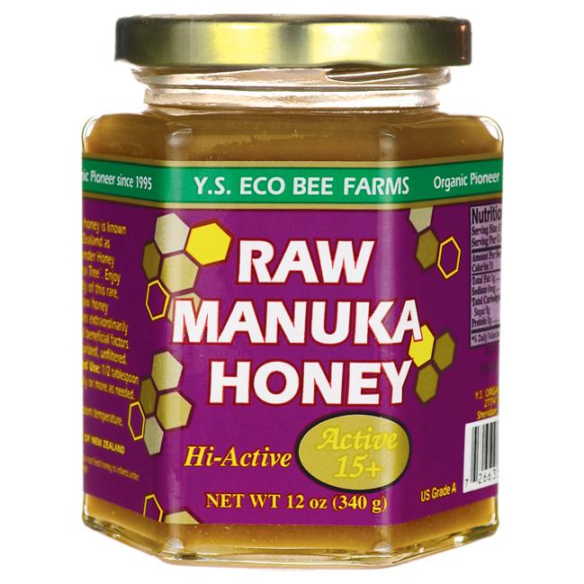 glass jar of manuka honey with a purple label
