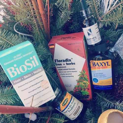 Biosil, Floradix, Baxyl, Probiotica, and vitamin D in a holiday floral arrangement
